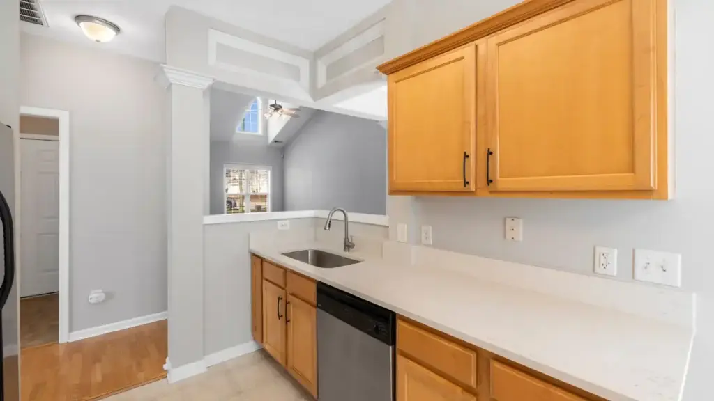 Modern kitchen renovation with clean maple cabinets, white quartz countertops, and stainless steel appliances - Concord's Handyman Crew kitchen renovation services in Concord NC