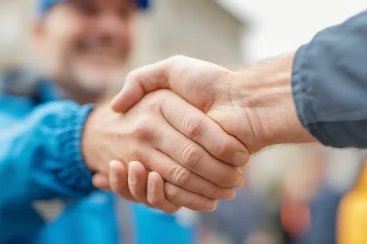 Close-up of a technician and homeowner shaking hands during a home repair visit in Concord, NC. Home repair in Concord NC showing Concord’s Handyman Crew handyman services